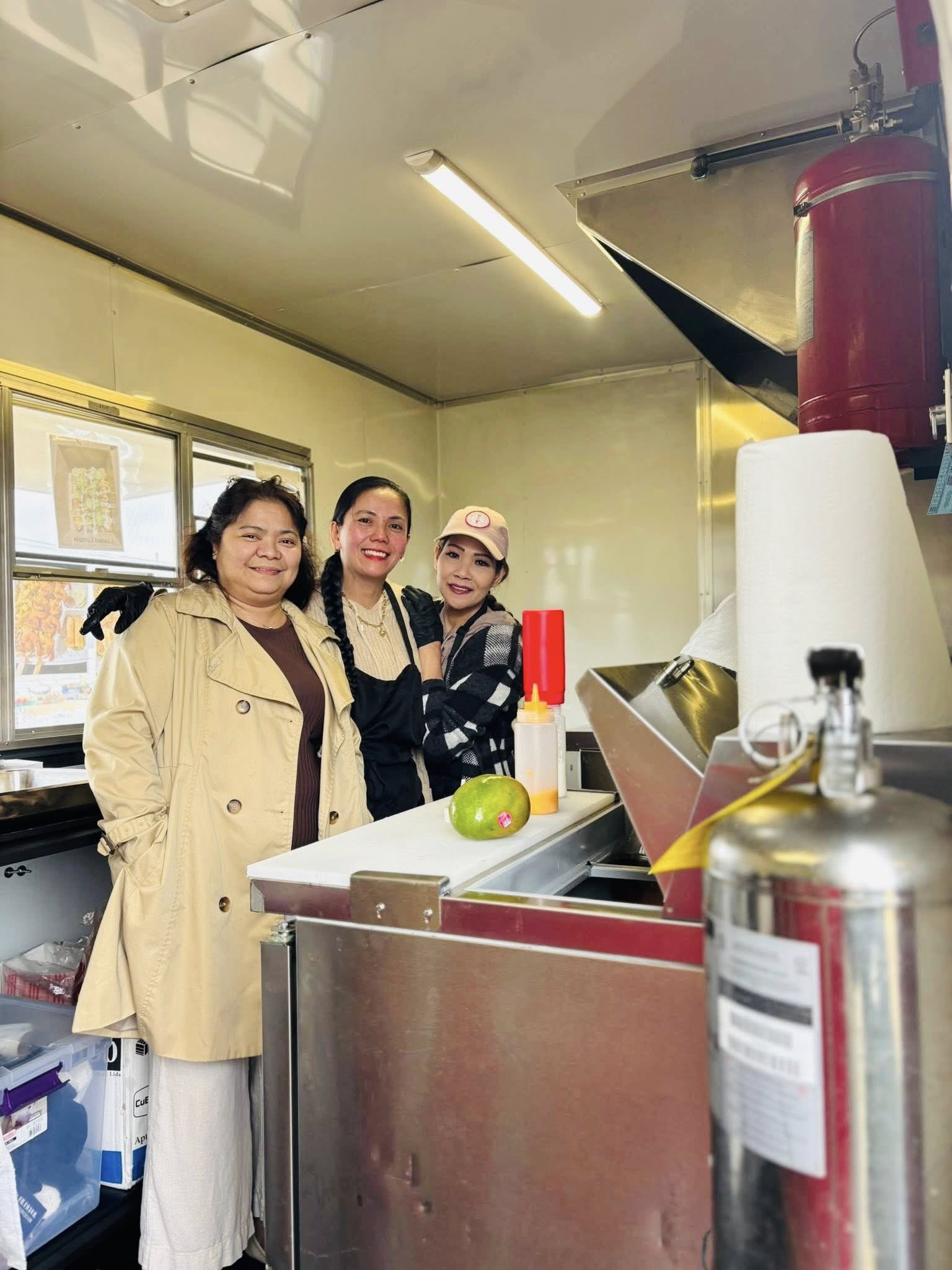 Food truck team members inside the Lor's Philippine Cuisine kitchen area