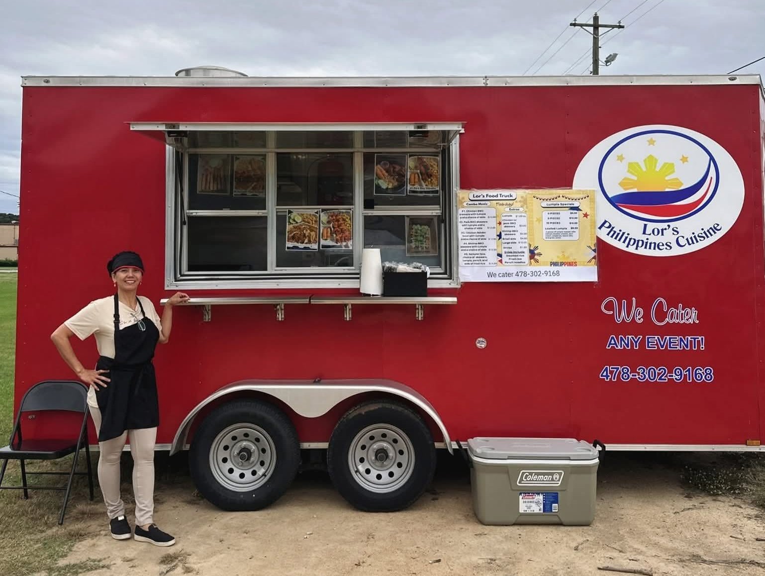 Lor standing beside the red Lor's Philippine Cuisine food truck